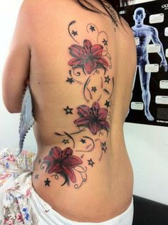 a woman's back with flowers and stars on it