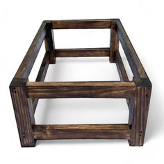 a square wooden table with one section missing from the top and another part missing from the bottom