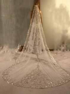 the back of a wedding dress is shown in front of a mirror