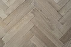 an image of wood flooring that looks like chevron herringbones in grey tones