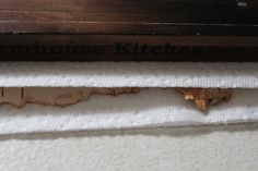 a piece of wood with the words farmhouse kitchen on it