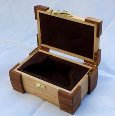 an open wooden box sitting on top of a white table