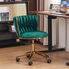 a green office chair sitting in front of a desk with a laptop computer on it