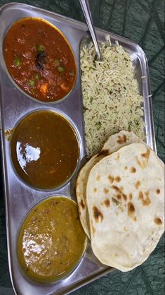 a metal tray filled with different types of food