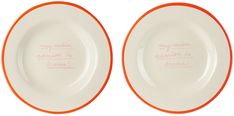 two orange and white plates with writing on them