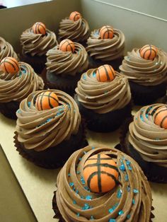 chocolate cupcakes with basketball decorations in a box