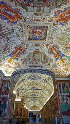 the ceiling is painted with many different colors and designs, as well as paintings on the walls