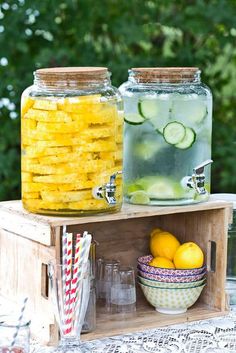 two mason jars filled with lemonade and cucumbers