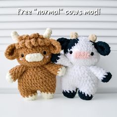 two small stuffed animals sitting next to each other on top of a white surface with the words free normal cows mod