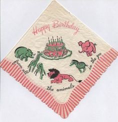 a happy birthday napkin with animals on it and a cake in the middle, sitting on top of a table