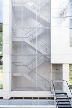 a white building with some stairs in front of it