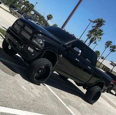 a large black truck parked in a parking lot