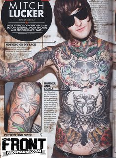 a man with lots of tattoos on his chest and arms, in front of a magazine page