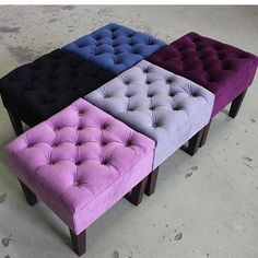 four different colored tufted stools sitting side by side