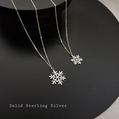 Sterling silver silver snowflake necklaces, these dainty necklaces  are perfect for the holiday season! The beautiful design features a cubic zirconia center stone for  extra sparkles. Crafted with hypoallergenic sterling silver. Great Christmas present or stocking stuffer. Size of charms:15.5mm, 19.5mm Comes with gift box ready for gift giving. Necklace length: 17.5'' +1-2'' extender, please leave a note at check out if you would like a  different length. Silver Snowflake Necklace For Anniversary, Christmas Silver Cubic Zirconia Necklace, Silver Snowflake Necklace With Cubic Zirconia, Silver Cubic Zirconia Necklaces For Christmas, Silver Cubic Zirconia Snowflake Necklace, Elegant Silver Jewelry For Winter, Sterling Silver Snowflake Jewelry For Winter, Silver Snowflake Necklace For Holiday, Silver Snowflake Jewelry For Holidays