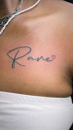 a woman's chest with the word rave tattooed on her left shoulder and heart