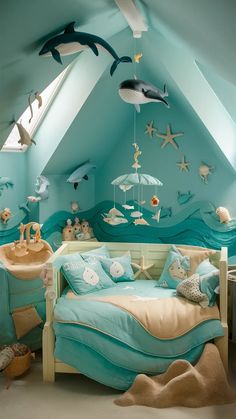 a child's bedroom decorated in blue and green with sea animals on the walls