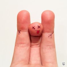 two fingers with small faces drawn on them