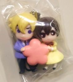 two figurines sitting on top of a plastic bag