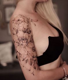 a woman with a flower tattoo on her arm