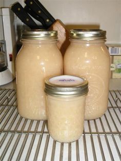 three jars sitting on top of a wire rack