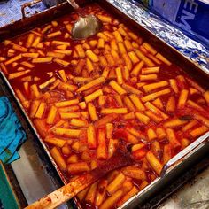 a large metal pan filled with food on top of a table