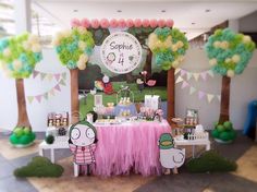 the table is set up for a birthday party with decorations and desserts on it