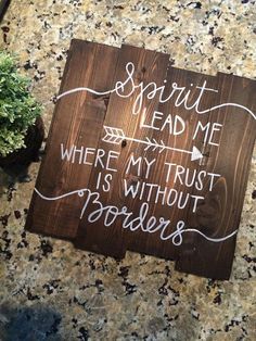 a wooden sign that says, spirit lead me where my trust is without borderers