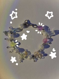 a rainbow beaded bracelet that's been made with plastic beads and faux pearls!! Cloud Bracelet, Rainbow Clouds, Rainbow Cloud, Rainbow Beads, Plastic Beads, A Rainbow, Chester, Beaded Bracelet, Faux Pearl