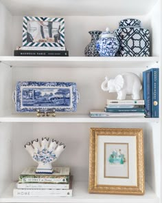 the shelves are filled with blue and white vases, books, and other decorative items