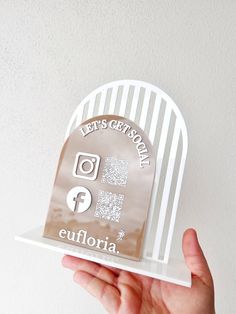 a person holding up an award in front of a white wall with the words, let's get today on it