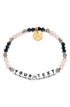 Crystal beads and brassy accents charm this customizable stretch bracelet that lets you add a playful statement of up to 13 characters to your wrist. Customizable with a message of up to 13 characters Glass/acrylic/goldtone plate/textile Imported Latinx Owned/Founded Black Beaded Bracelets With Letter Print As Gift, Black Beaded Bracelet With Letter Print As Gift, Personalized Inspirational Black Bracelets, Trendy Black Birthday Bracelets, Inspirational Personalized Black Bracelets, Adjustable Black Charm Bracelet With Letter Beads, Personalized Black Stretch Bracelet For Friendship, Customized Black Trendy Stretch Bracelet, Black Novelty Stretch Bracelet As A Gift