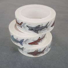 three rolls of washi tape with sharks on them