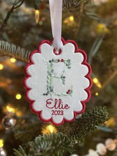 a personalized ornament hanging from a christmas tree