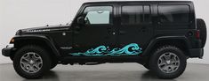 a black jeep with blue waves painted on it's side