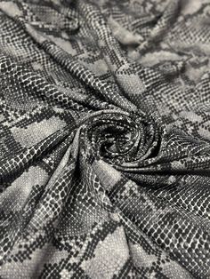 a black and white photo of a checkered fabric with an intricate design on it