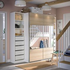 a room that has some shelves and drawers in it with a clock on the wall