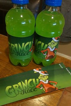 two bottles of grin juice sitting on top of a table