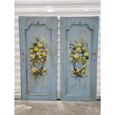 two blue doors with yellow flowers painted on them