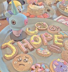 there are many decorated cookies on the table with an animal figure in the middle and letters that spell out