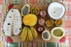 various fruits are arranged on a cutting board