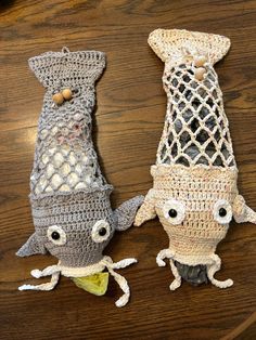 two crocheted items sitting on top of a wooden table