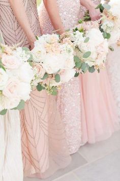 the bridesmaids are holding their bouquets together