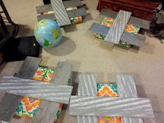 several pieces of wood sitting on top of a floor next to a ball and chair