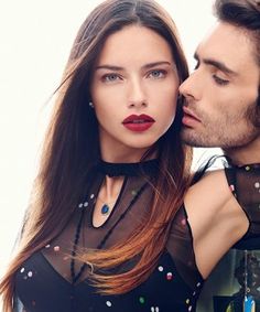 a man kissing a woman on the cover of bazaar