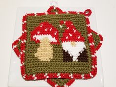 two crocheted christmas coasters sitting on top of a white plate