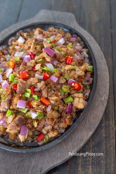 a skillet filled with food on top of a wooden table