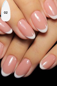 a woman's hand with pink and white nail polish on her nails, showing the tip