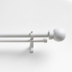 an image of a white curtain rod with two balls on it's end and one ball at the end