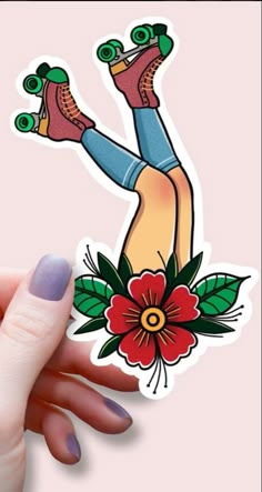 a woman's hand holding up a sticker with her feet in the air